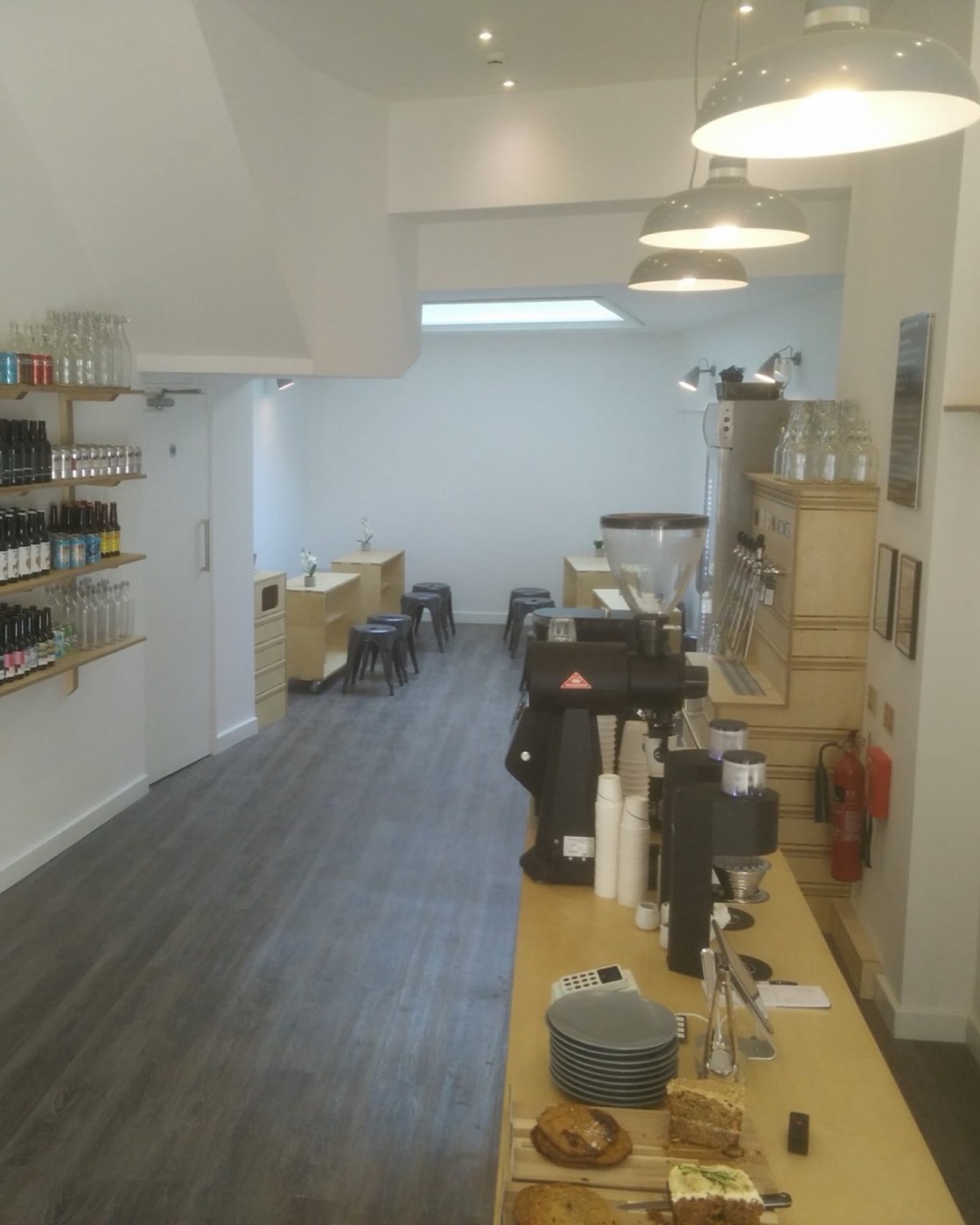 Looking down the bar at Coffee + Beer towards the skylight at the back